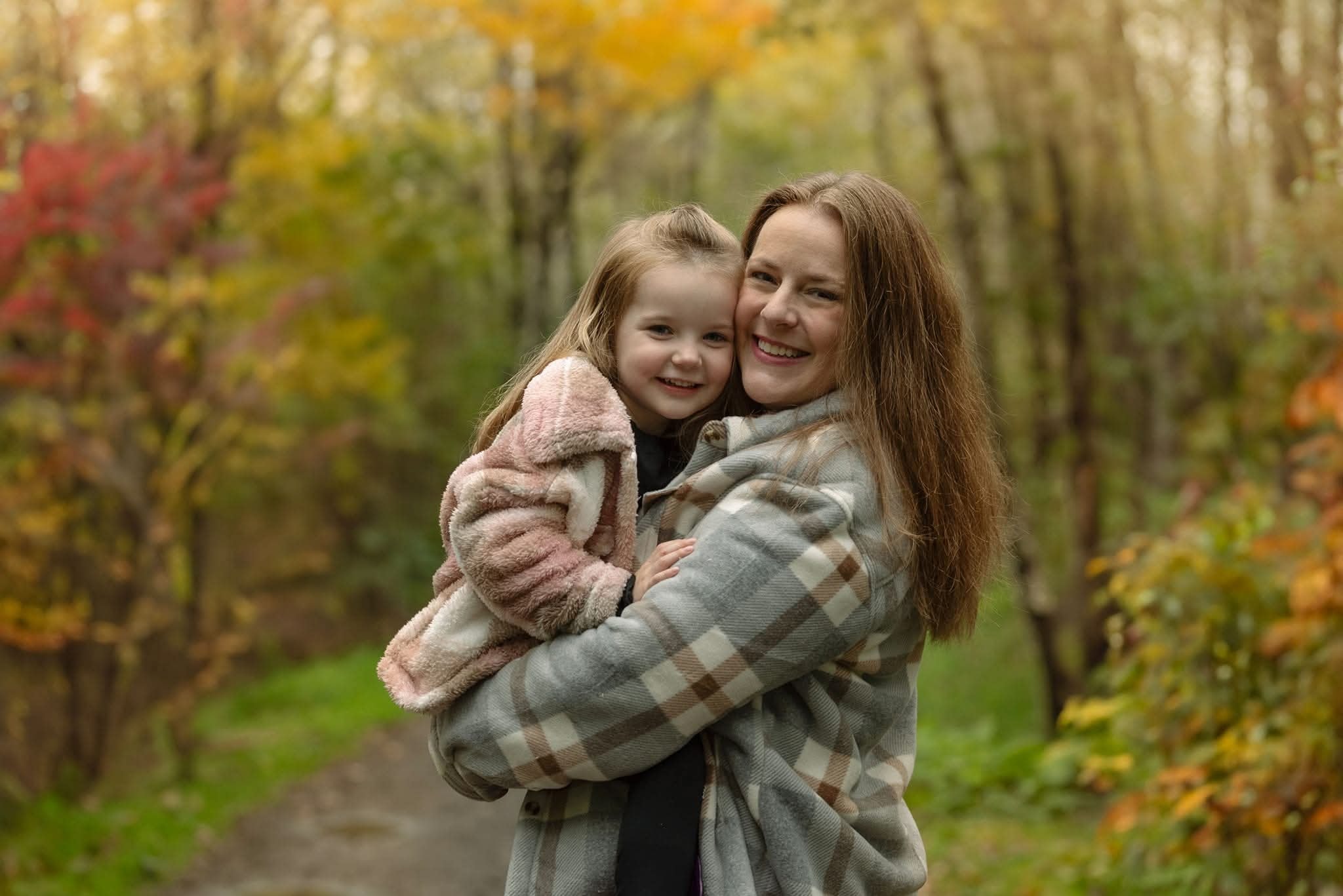 Shelley holding Ella in an autumn forest